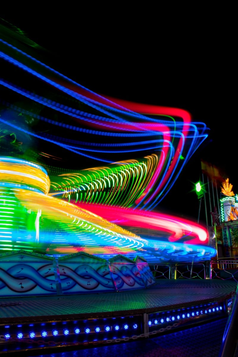 a blurry photo of a carnival ride at night